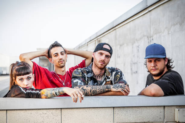 istock group of rappers posing leaning against the wall 1046102354
