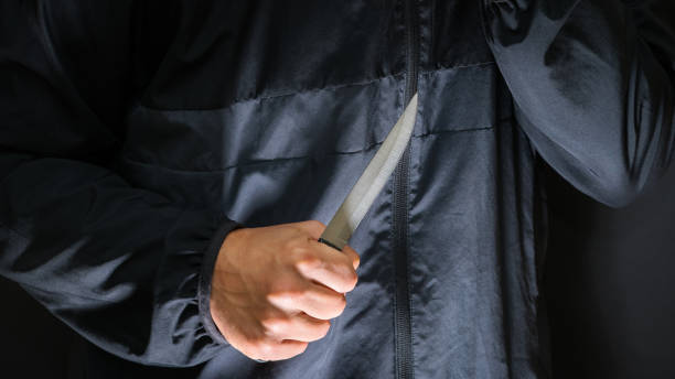 Street robber with a knife - killer person with sharp knife about to commit a homicide, murder scenery Street robber with a knife - killer person with sharp knife about to commit a homicide, murder scenery knife weapon photos stock pictures, royalty-free photos & images