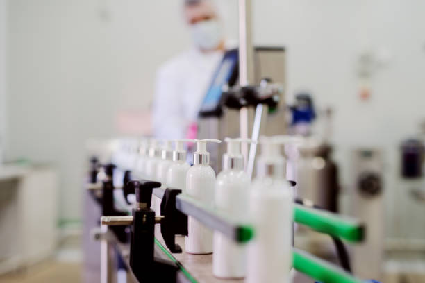 Picture of lotion bottles on production line. Bottles of cosmetic products in factory production line. Picture of lotion bottles on production line. Bottles of cosmetic products in factory production line. beauty product stock pictures, royalty-free photos & images