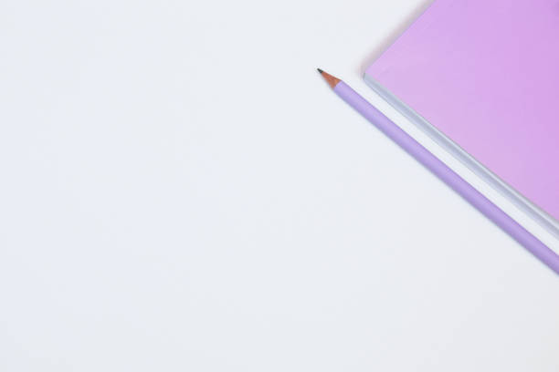 istock Pink notebook and pencil on white background. Selective focus 1046125470