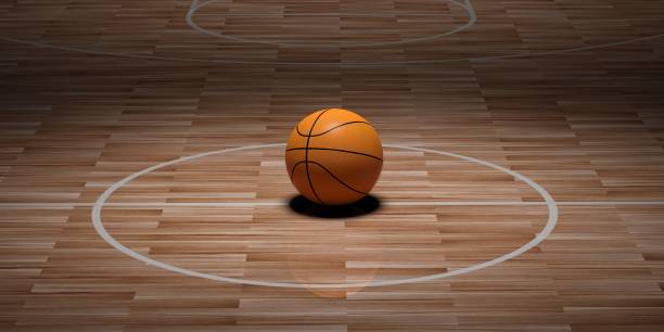 istock 3d rendering basketball on wooden background 1046128690