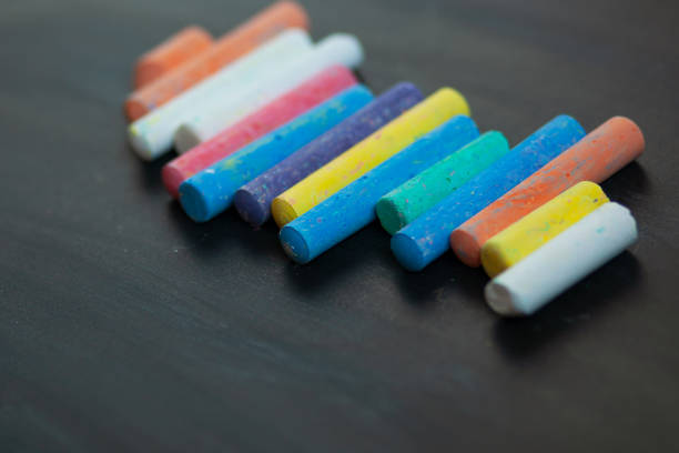 istock Black chalkboard with colorful pieces of chalk. 1046134304