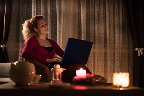 istock Young woman using laptop in cozy living room. 1046140896