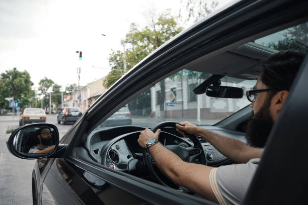 istock Modern casual bearded man driving a car 1046145390