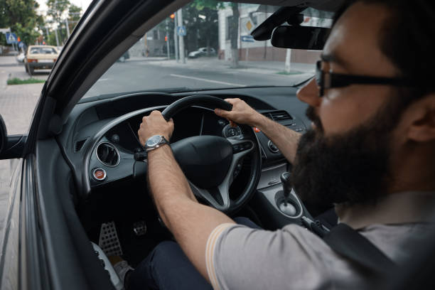 istock Modern casual bearded man driving a car 1046145402