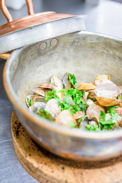 istock Clams with garlic and coriander in copper pot 1046149822