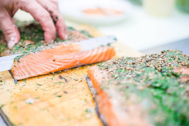 istock Cutting delicious salmon with herbs into slices 1046149946