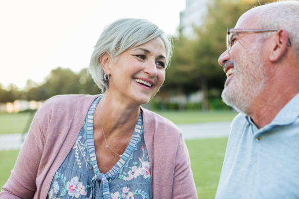 istock Cheerful couple relax in park 1046150404