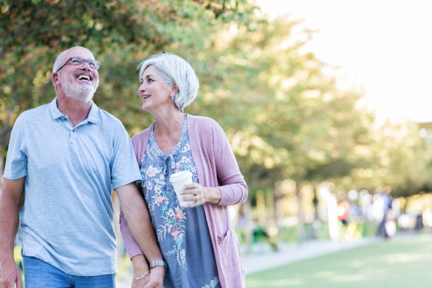 istock Couple walking in public park 1046150452