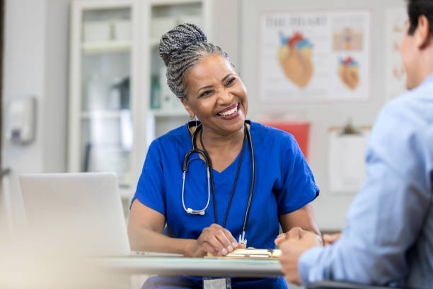 istock Cheerful medical professional meets with patient 1046150506