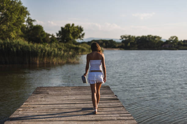 istock Lady walking near lake 1046152884