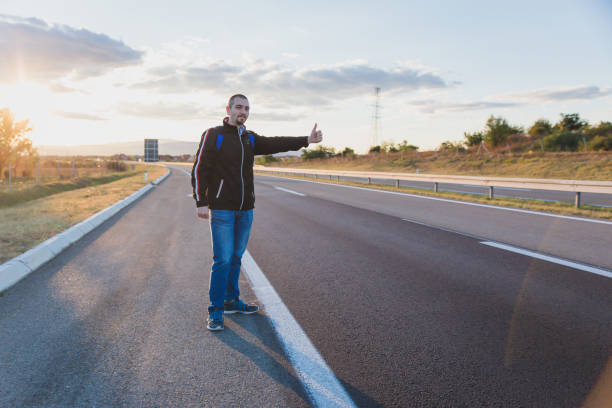 istock Hitchhiker try to stop transport 1046156380