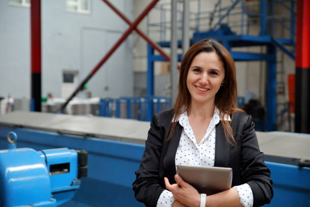 istock Successful  female entrepreneur standing in factory 1046168510