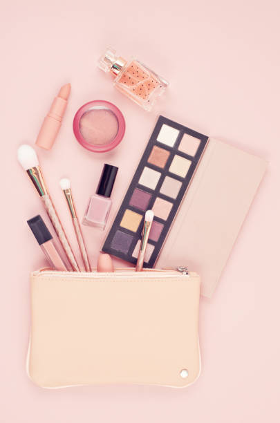 istock Makeup cosmetic products over pastel pink background, flat lay, top view 1046172420