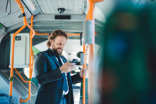 istock Businessman using smart phone on the bus 1046174780