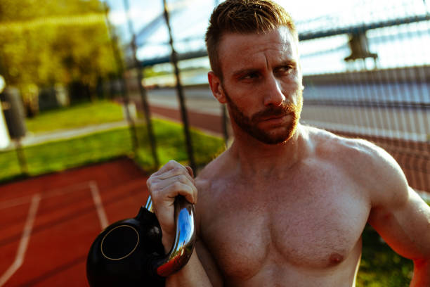 istock Fitness young man training with kettlebell at dawn 1046175790