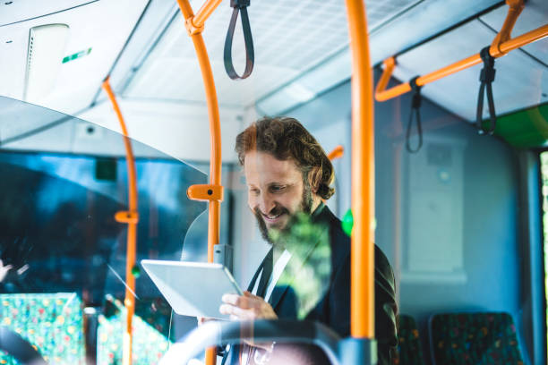 istock Businessman using smart phone on the bus 1046178000