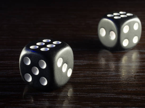 istock Table gambling with dice in the evening with dim light on a dark background 1046178818