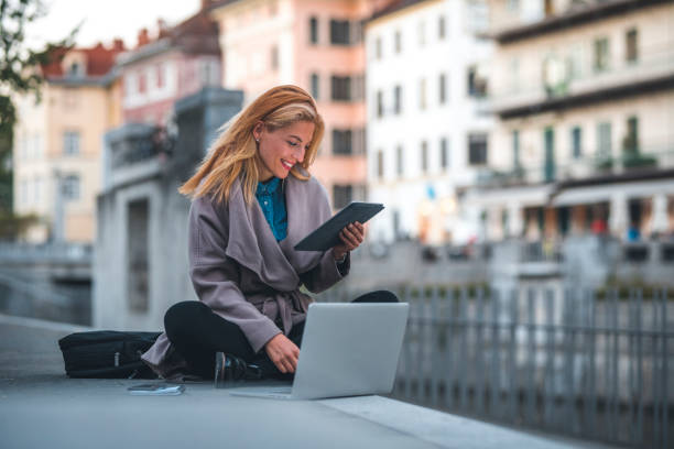 donna che lavora all'aperto in città - mobility working digital tablet people foto e immagini stock