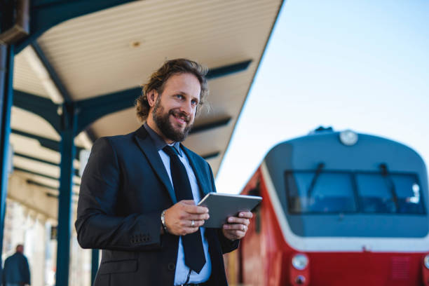 istock Businessman using a digital tablet at the train station 1046184368