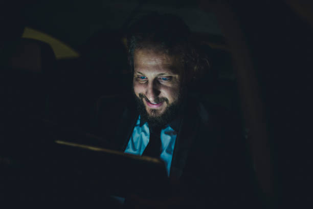 istock Businessman using digital tablet in the car 1046184428