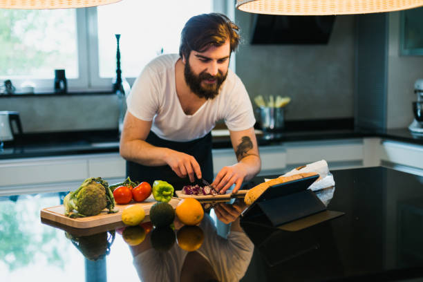 istock Young man preparing healthy meal in the kitchen 1046187112