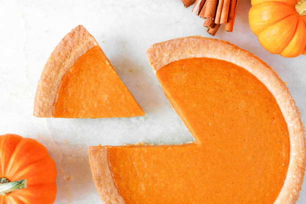 istock Pumpkin pie with slice removed, top view, close up 1046187240