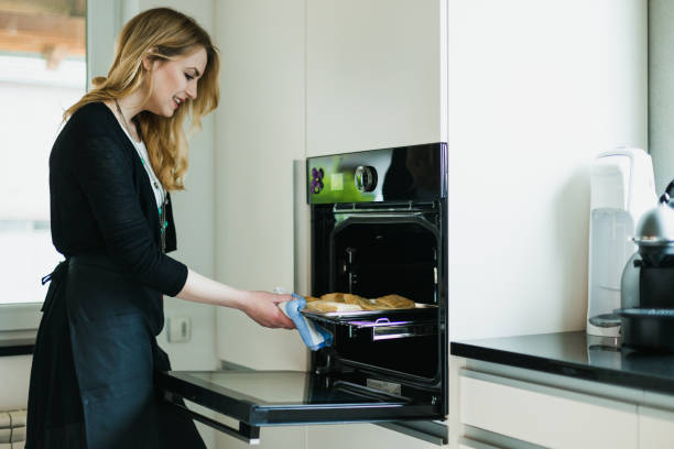 istock Beautiful young woman baking pastries in the kitchen 1046187658