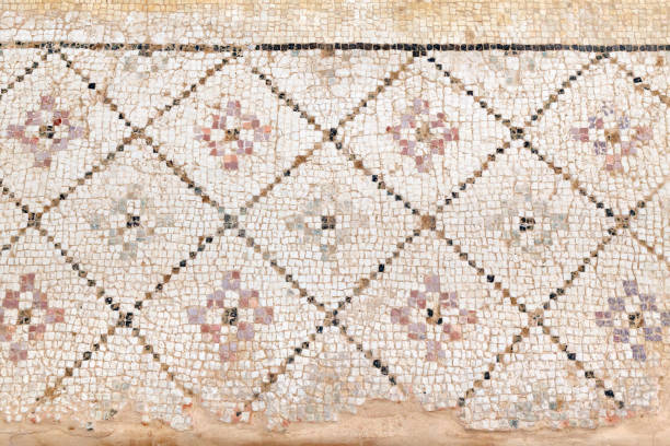 istock Ancient, antique mosaic of small colored tiles with geometric pattern. 1046190302