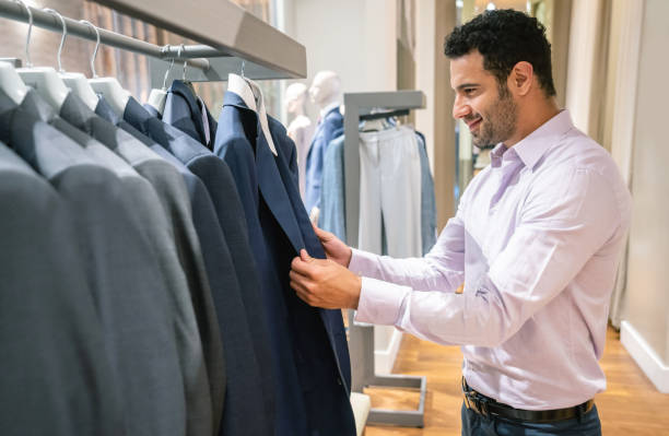 istock Happy man shopping for clothes at a store 1046208350
