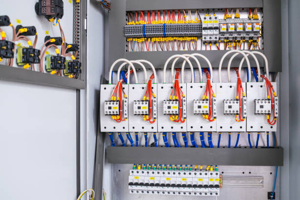 istock Open electrical box with switching equipment.Many wires, contacts and terminal blocks close-up. Multicolored cables are connected to a single network 1046211654