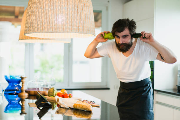istock Bearded man cooking and having fun in the kitchen 1046212990
