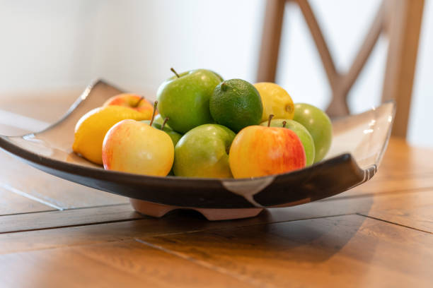 istock Fresh yellow and red apples in a bowl on a table 1046226086