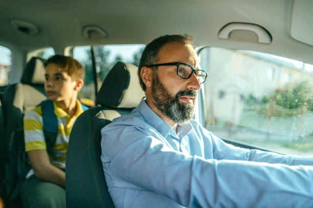 istock Dad drives his son in school 1046229290