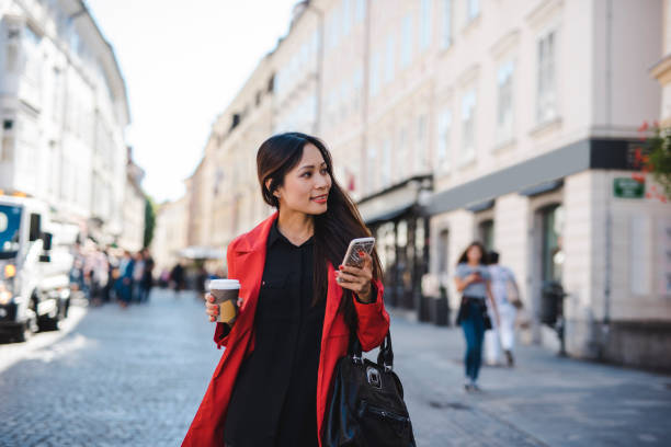 istock Businesswoman using smart phone in the city 1046231982