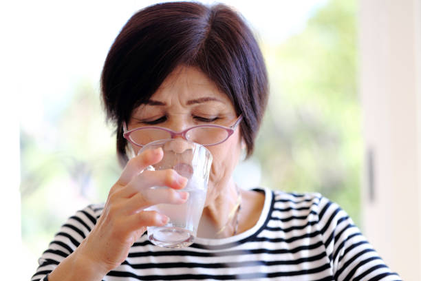 istock Senior woman drinking water 1046234398