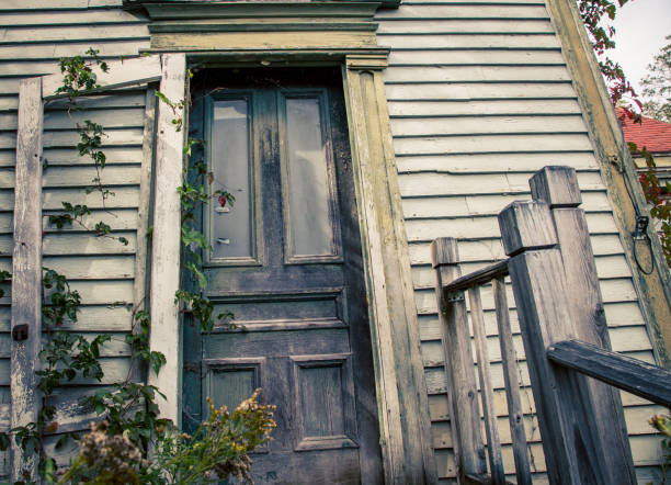 Old wooden door on an abandon house and steps