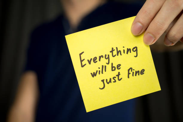 istock Man holds yellow sticker inscription Everything will be just fine. 1046248870