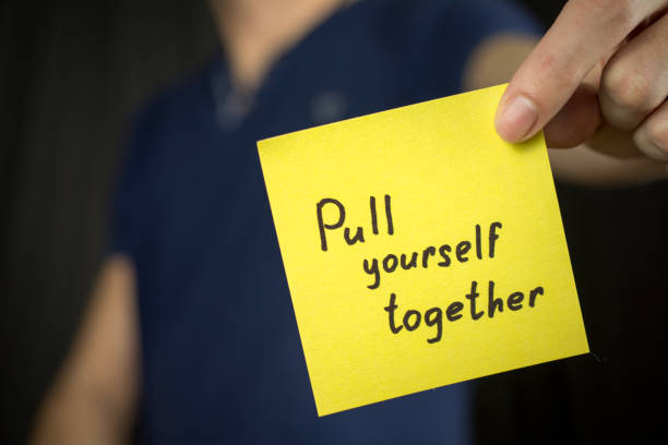 istock Man holds yellow sticker inscription Pull yourself together. 1046249016