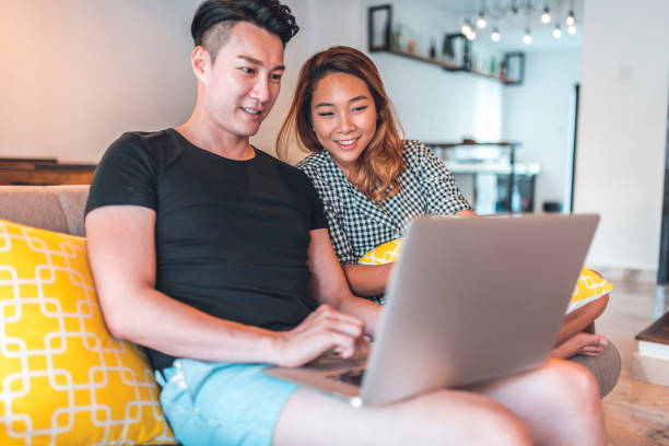 istock Happy young couple using laptop at home 1046249664