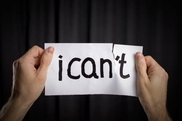 istock hands rip up poster inscription I can't to I can. 1046249694