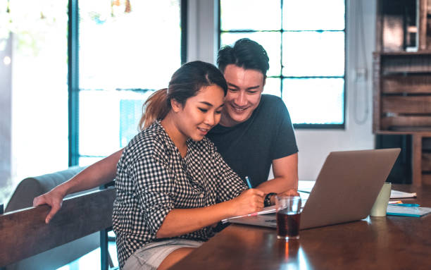 istock Smiling young couple planning budget at home 1046249714