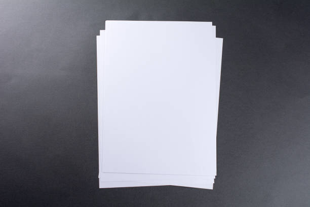 istock Blank sheets of paper gray background 1046249984