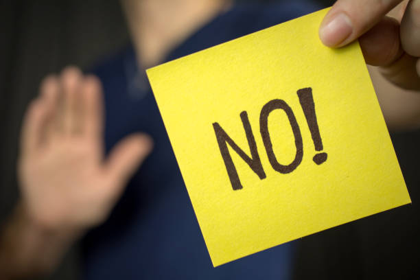istock Man holds yellow sticker inscription No! 1046252114