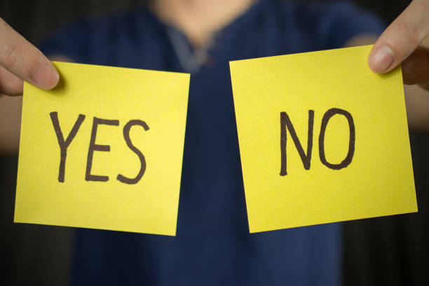 istock Man holds yellow sticker inscription Yes No. 1046252340