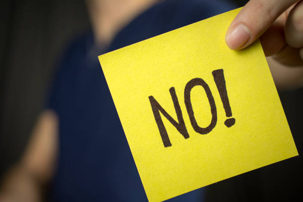 istock Man holds yellow sticker inscription No! 1046252434