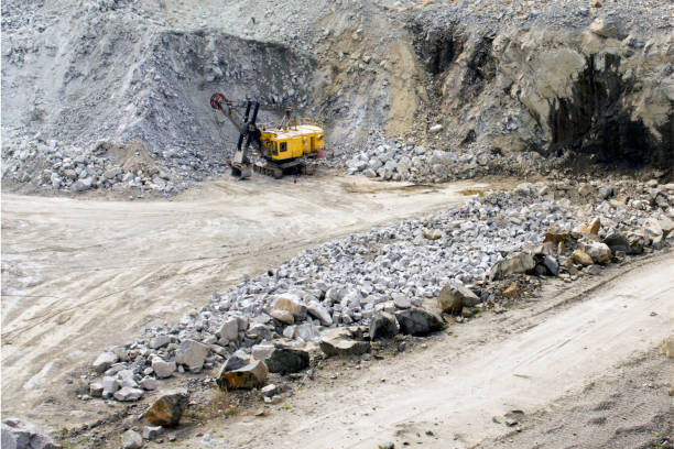 Excavator works quarrying extraction of aluminum ore. stock photo