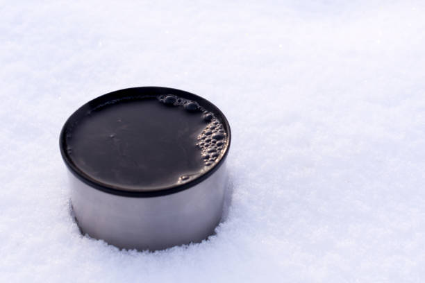 istock pours hot tea from a thermos outdoors  in the snow 1046256218