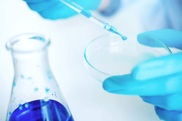 istock Scientist with equipment holding tools during scientific experiment science concept 1046283462