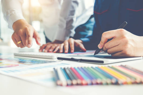 istock Two Graphic designer drawing on graphics tablet and color palette guide at workplace 1046283494